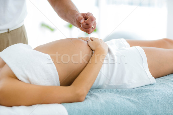 Pregnant woman receiving a spa treatment from masseur Stock photo © wavebreak_media