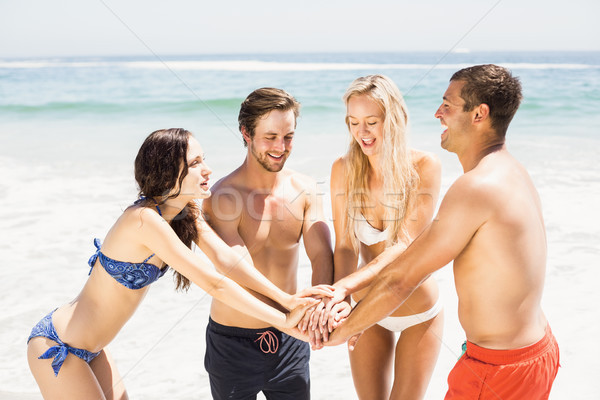 Jeunes amis mains ensemble plage [[stock_photo]] © wavebreak_media