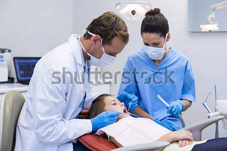 Female doctor examining patient with stethoscope in ward Stock photo © wavebreak_media