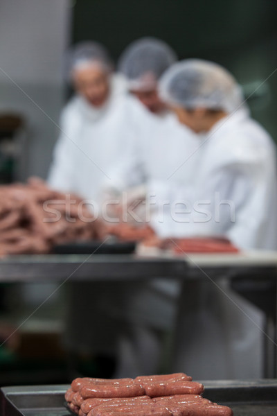 Stock photo: Raw sausages arranged on tray at meat factory