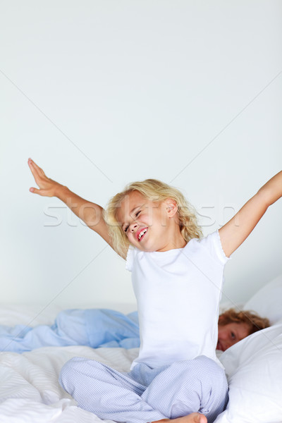 Little girl stretching in bed Stock photo © wavebreak_media
