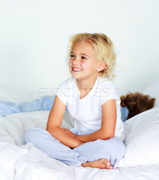 Adorable littl girl with brother on the bed against white background Stock photo © wavebreak_media