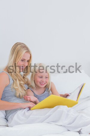 Siblings hugging sitting on the bed Stock photo © wavebreak_media