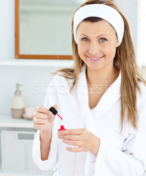 Positive caucasian woman varnishing her fingernails in the bathroom at home Stock photo © wavebreak_media