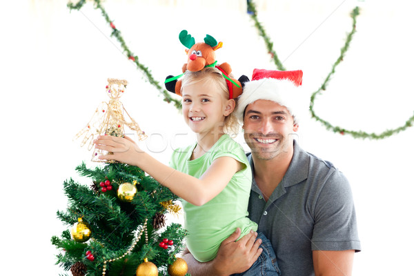 Happy father and daughter decorating together the christmas tree at home Stock photo © wavebreak_media