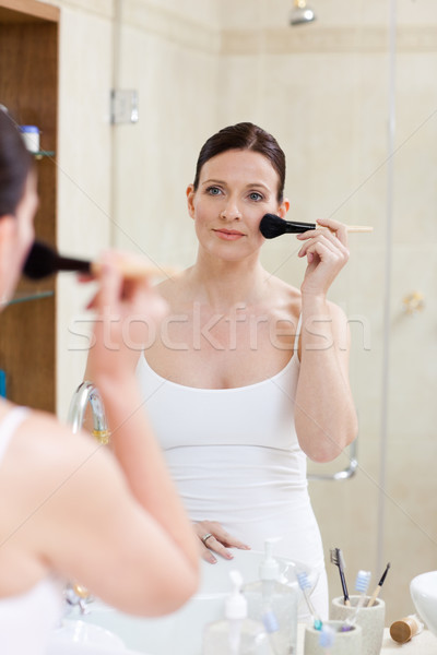 Beautiful women putting make up on  Stock photo © wavebreak_media