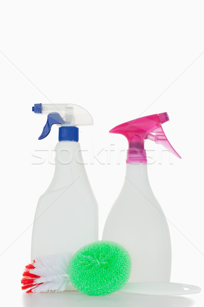 Pink and blue spray bottles and a brush against a white background Stock photo © wavebreak_media