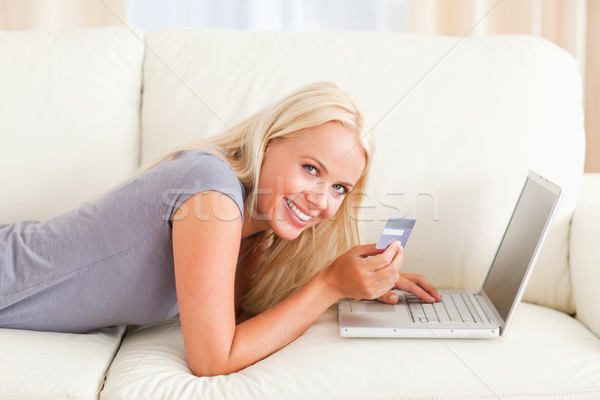 Smiling woman purchasing online in her living room Stock photo © wavebreak_media