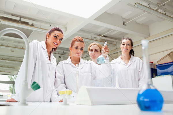 Smiling chemistry students holding a flask while looking at the camera Stock photo © wavebreak_media