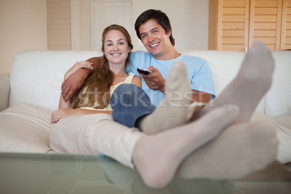 Relaxed young couple watching television in their living room Stock photo © wavebreak_media