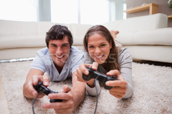 Stock photo: Young couple playing video games in the living room