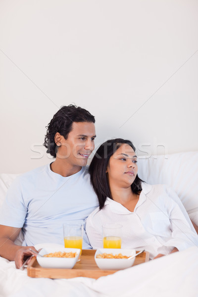 Young couple eating breakfast in the bed Stock photo © wavebreak_media