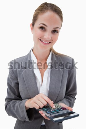 Stock photo: Smiling bank employee with pocket calculator against a white background