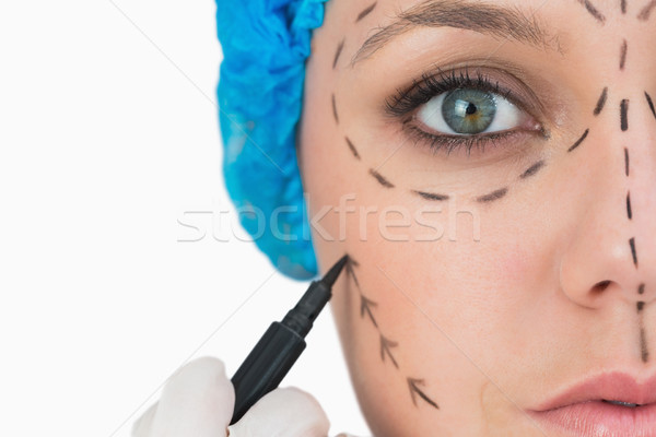 Stock photo: Plastic surgeon marking face on white background