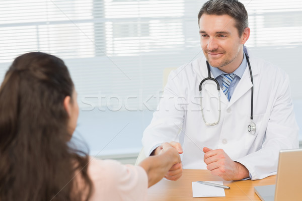 Doctor and patient shaking hands in medical office Stock photo © wavebreak_media