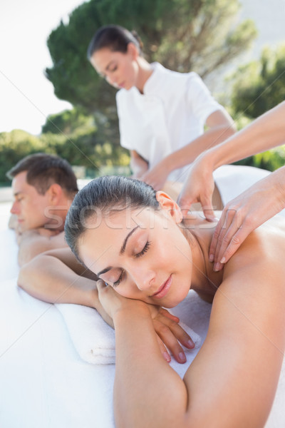 Attractive couple enjoying couples massage poolside Stock photo © wavebreak_media