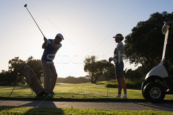 Golfing couple teeing off for the day Stock photo © wavebreak_media