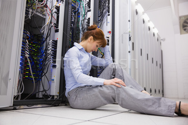 Stressed technician sitting on floor beside open server Stock photo © wavebreak_media