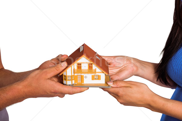 Young couple holding a model house Stock photo © wavebreak_media