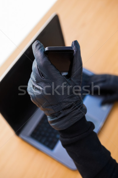 Hands with leather gloves using laptop and smartphone Stock photo © wavebreak_media