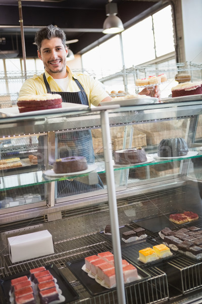 Portrait of smiling worker behind the dessert Stock photo © wavebreak_media