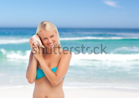 Happy pretty blonde looking at camera into the sea Stock photo © wavebreak_media