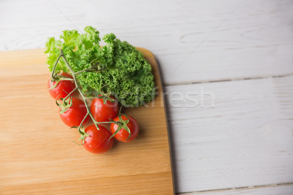 Planche à découper tomates persil coup studio cuisine [[stock_photo]] © wavebreak_media