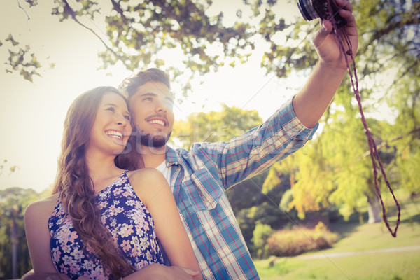 Cute couple doing selfie with retro camera in the park Stock photo © wavebreak_media