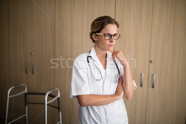 Thoughtful female doctor with hand on chin Stock photo © wavebreak_media