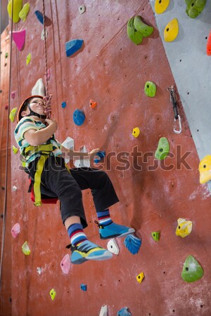 Determined woman practicing rock climbing Stock photo © wavebreak_media