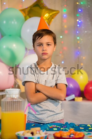 Cute boy standing with birthday cake Stock photo © wavebreak_media