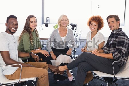 Side view of senior friends holding hands while siting on chair Stock photo © wavebreak_media