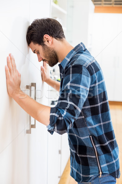 Depressed man leaning his head against a door Stock photo © wavebreak_media