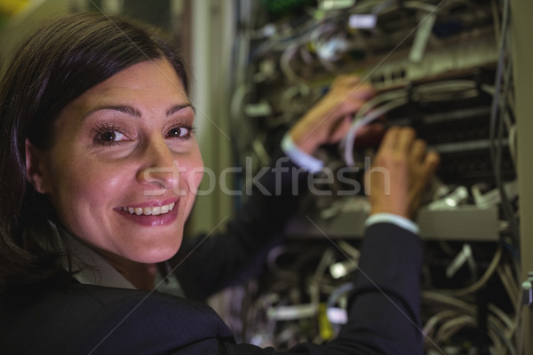 Portrait of technician checking cables in a rack mounted server  Stock photo © wavebreak_media