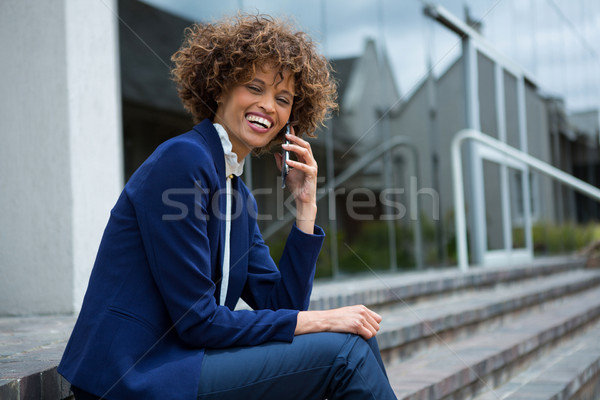 Businesswoman talking on mobile phone in the premises Stock photo © wavebreak_media