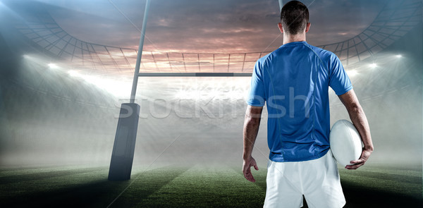 Composite image of rear view of rugby player holding ball aside Stock photo © wavebreak_media