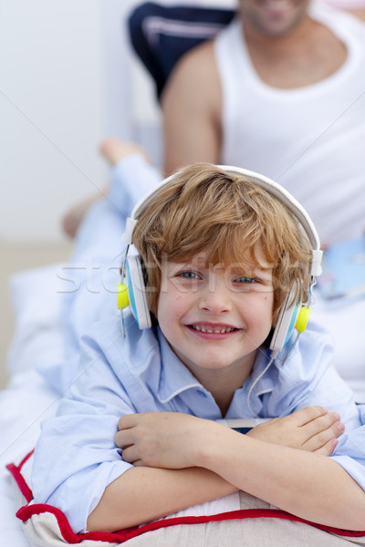 Portrait of a little boy listening to music in bedroom Stock photo © wavebreak_media