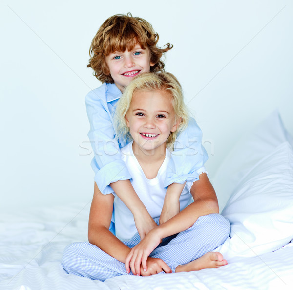 Little brother embracing his little sister in bed Stock photo © wavebreak_media