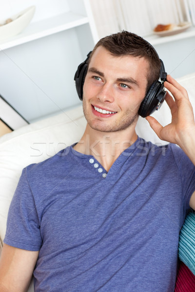 Good-looking man listening to music in living room Stock photo © wavebreak_media