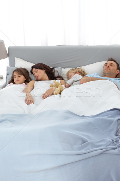 Peaceful family sleeping together in the parents's bed Stock photo © wavebreak_media