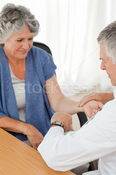 A senior doctor doing an examination of his patient in his office Stock photo © wavebreak_media