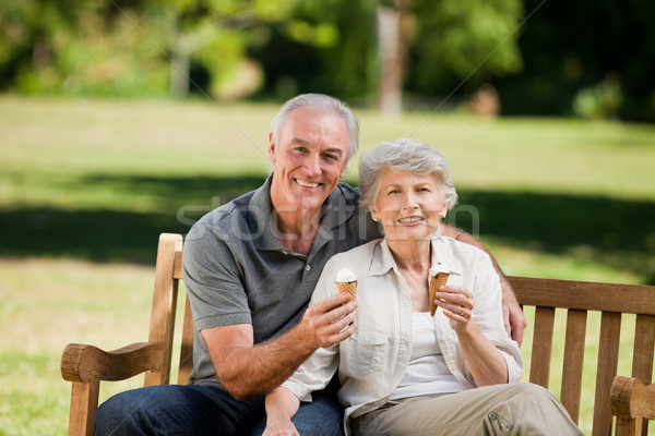 Senior couple eating an ice cream on a bench Stock photo © wavebreak_media