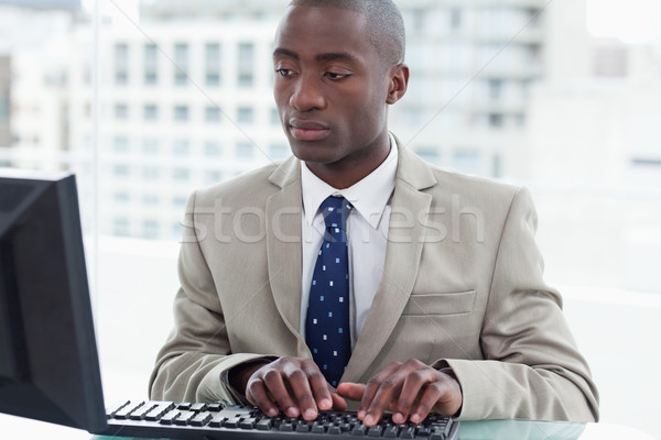 Office worker using a computer in his office Stock photo © wavebreak_media