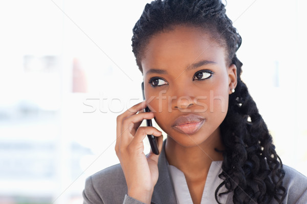 Young earnest employee talking on the phone in a bright room Stock photo © wavebreak_media