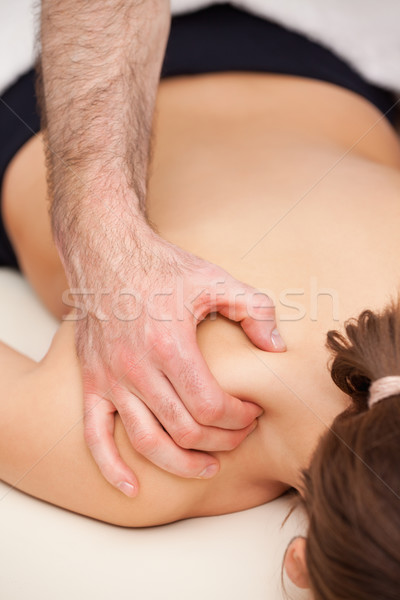 Doctor squeezing the top of the back of his patient in a room Stock photo © wavebreak_media
