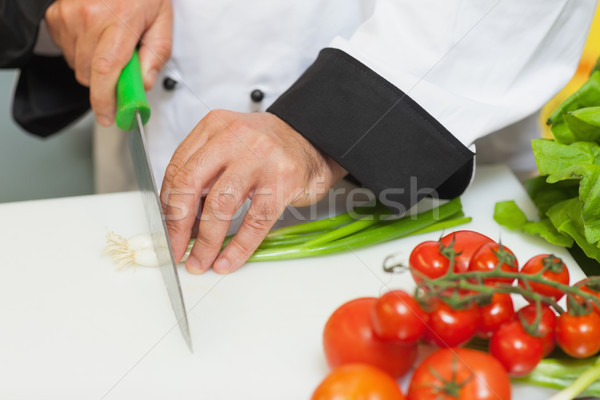 Chef cutting spring onions on chopping board Stock photo © wavebreak_media