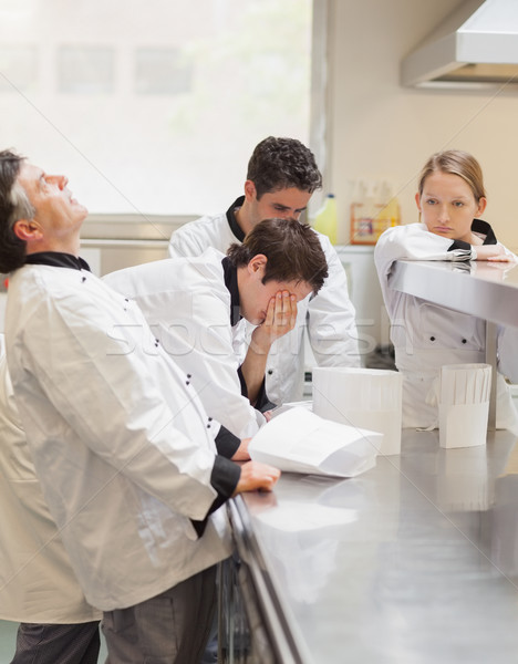 Stock photo: Frustrated Chef's discussing the menu n kitchen