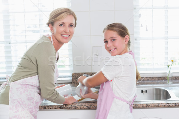 Happy mother and daughter washing up together  Stock photo © wavebreak_media