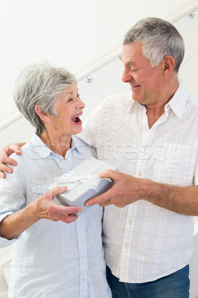 Senior man giving his surprised partner a gift Stock photo © wavebreak_media