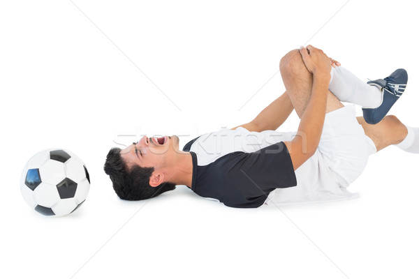 Soccer player lying down and shouting in pain Stock photo © wavebreak_media
